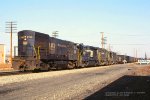 PC, Penn Central U23B 2755-U33B 2938- GP387837- U25B 2565 with VE-1 southbound on the ex-NYC River Line at Ridgefield Park, New Jersey. March 19, 1977. 